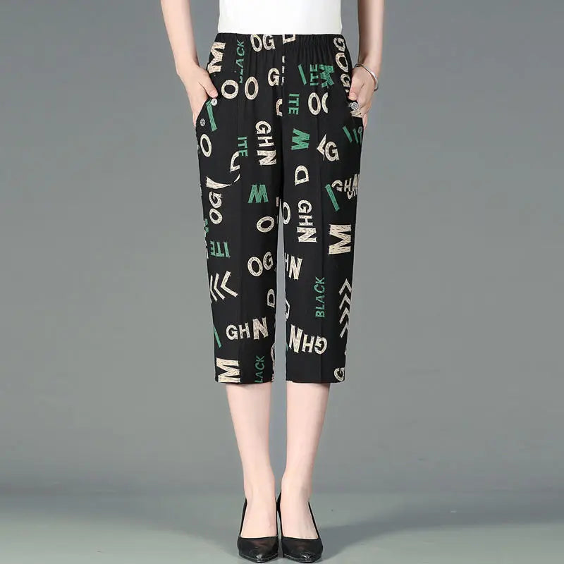 Summer new high waist Capri pants with elastic waist, casual loose straight fit, black fabric with colorful patchwork and printed letters, featuring pockets.