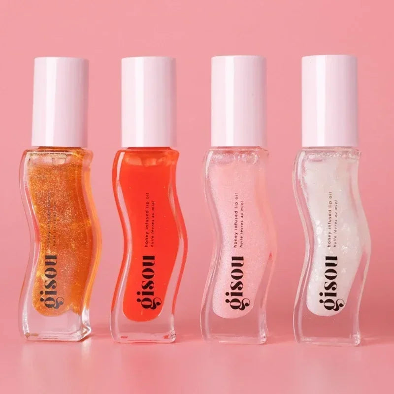 Gisou Moisturizing Watermelon Lip Balm Lip Oil Gloss Care Of The Lips benefits with four different colored glosses in pink