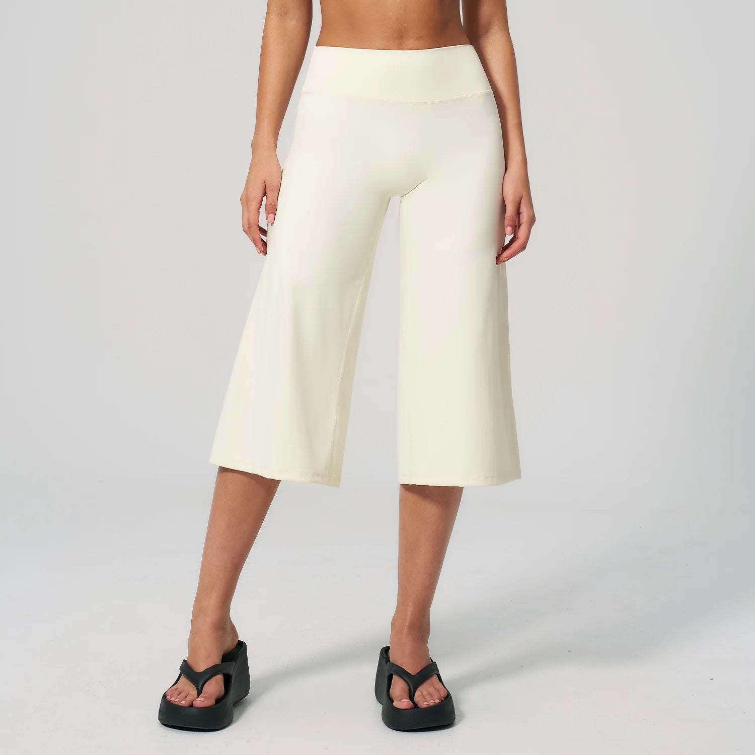 Summer Capri Pants for Women Wide Leg Yoga Cropped Pants Tummy Control High Waist in Flare Crop, buttery soft, loose casual style, worn with black platform sandals.