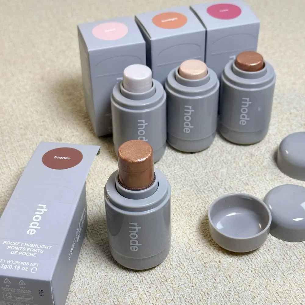 Rhode Highlight Stick set with four colors: brightening bronzo, sunlight pearl, rose, and bronze, in gray portable