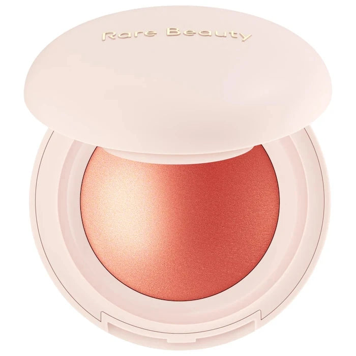 Rare Beauty Positive Light Powder Highlighter Blush with water-light shimmer in peachy shade, waterproof and long-lasting