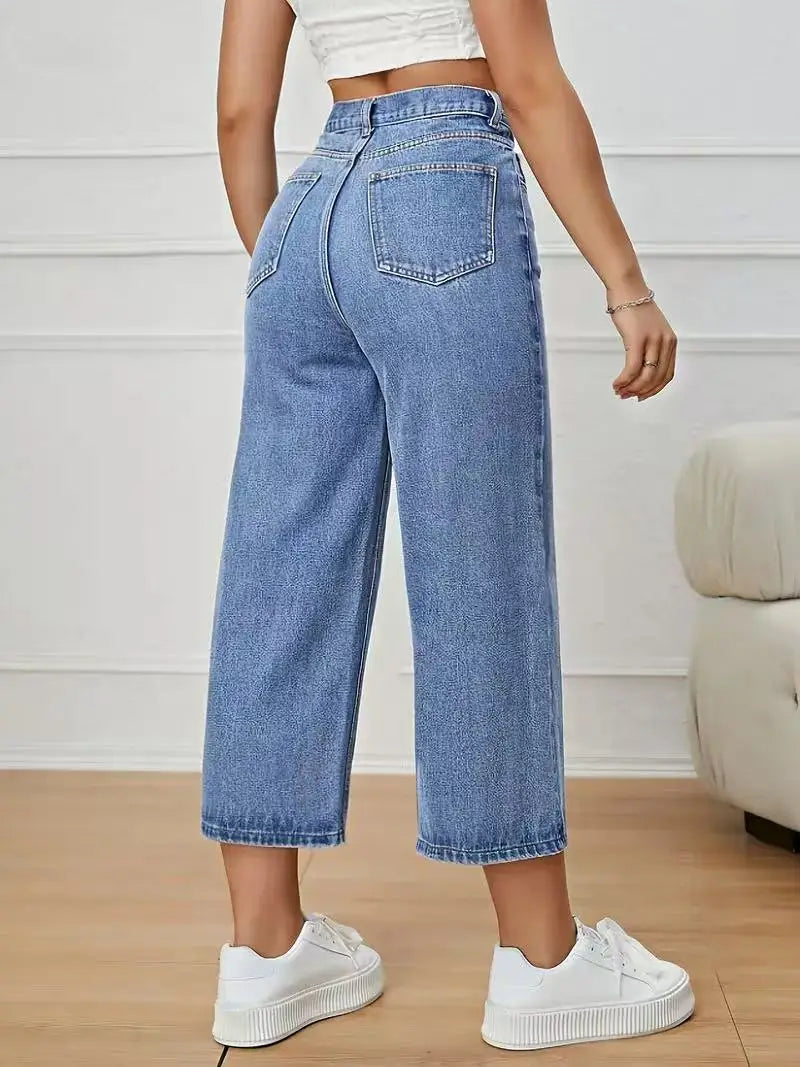 Women's High-Waisted Wide-Leg Capri Jeans in light blue denim with back pockets, styled with white sneakers and a white crop