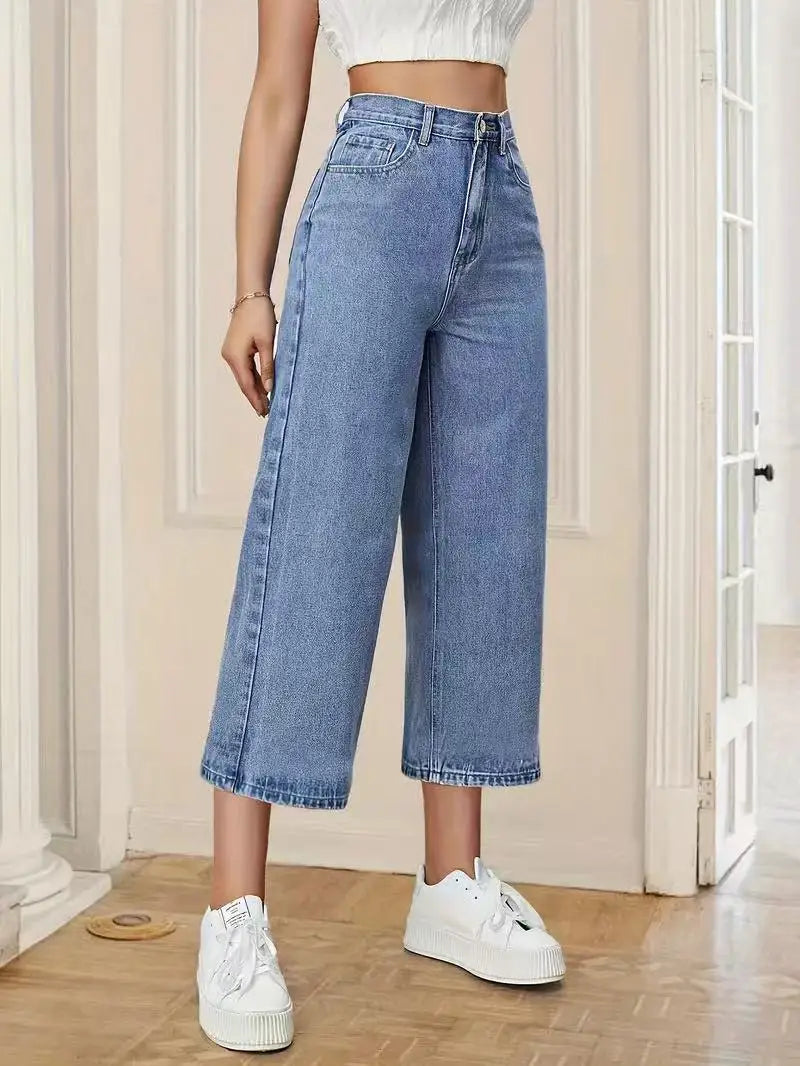 Women's High-Waisted Wide-Leg Capri Jeans in light blue denim with relaxed fit, cropped length, paired with white sneakers.